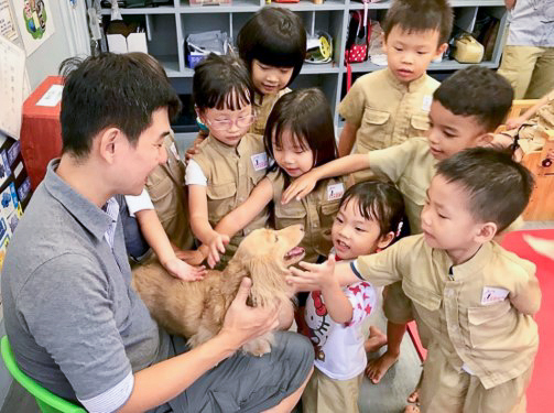 Children petting a dog